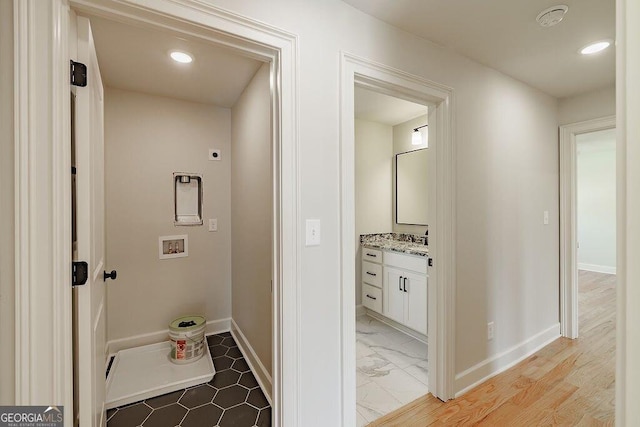 hallway featuring recessed lighting and baseboards