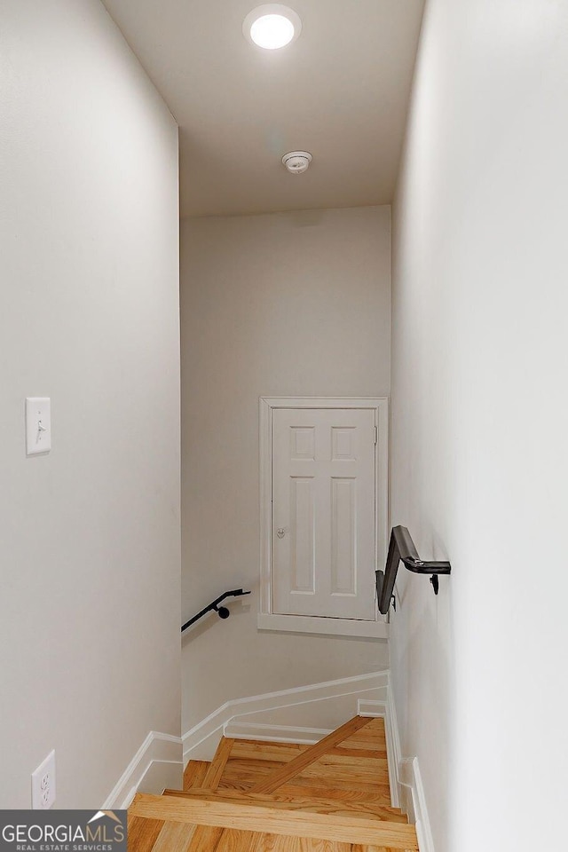 stairs featuring baseboards and wood finished floors