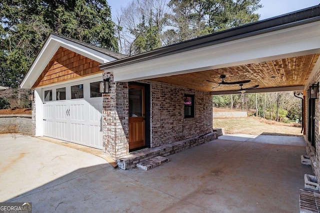 garage featuring ceiling fan and concrete driveway