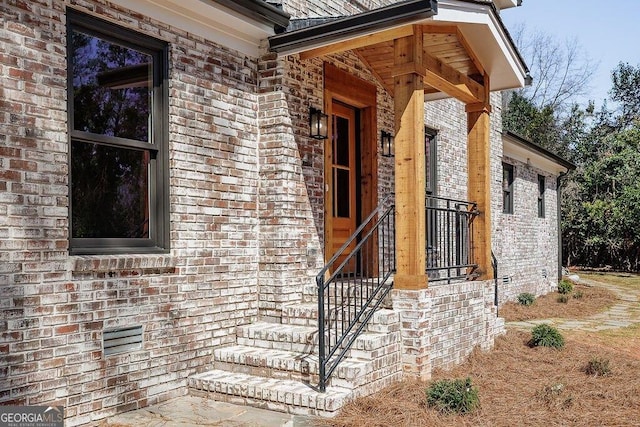 property entrance featuring brick siding