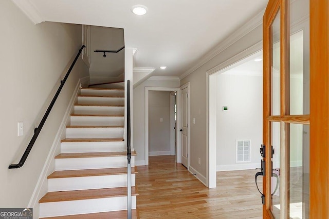 stairs with visible vents, baseboards, ornamental molding, recessed lighting, and wood finished floors