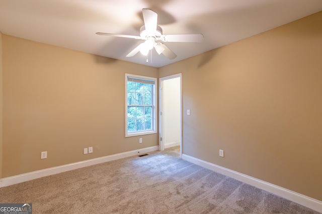 unfurnished room featuring visible vents, a ceiling fan, baseboards, and carpet floors