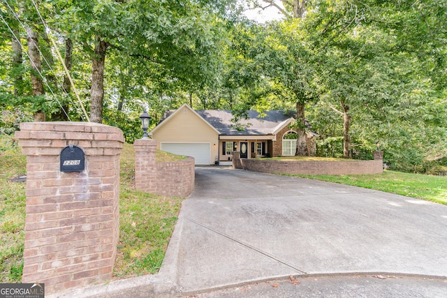 view of front of property with concrete driveway and an attached garage