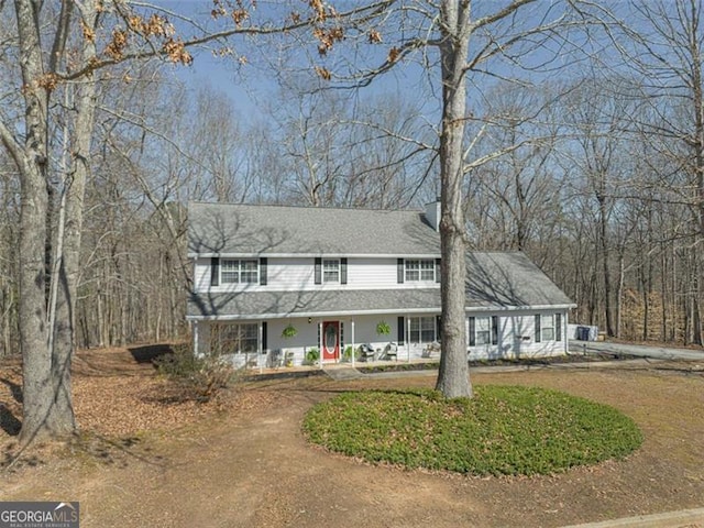 view of front of property with a chimney and a shingled roof