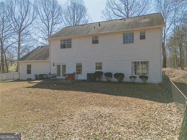 back of house with french doors, a patio area, roof with shingles, and fence