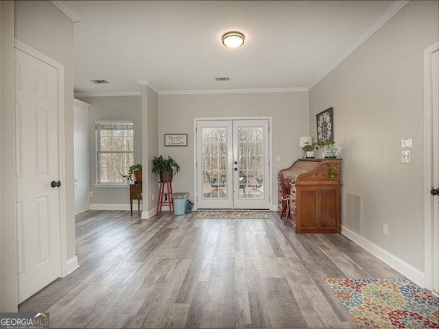 foyer with visible vents, french doors, and wood finished floors