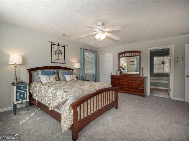 bedroom with visible vents, carpet floors, and a textured ceiling