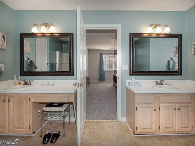 bathroom featuring vanity, tile patterned floors, and baseboards