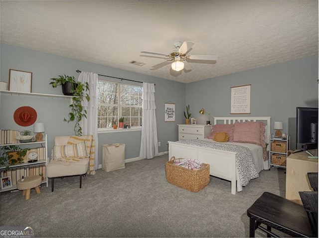 bedroom with visible vents, a textured ceiling, carpet flooring, and a ceiling fan