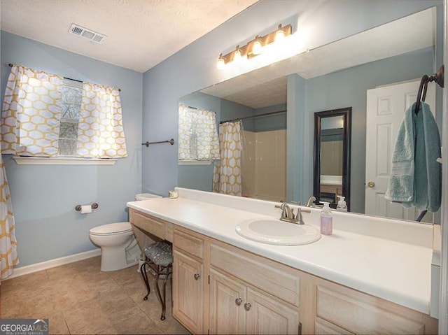 bathroom featuring vanity, baseboards, visible vents, a textured ceiling, and toilet