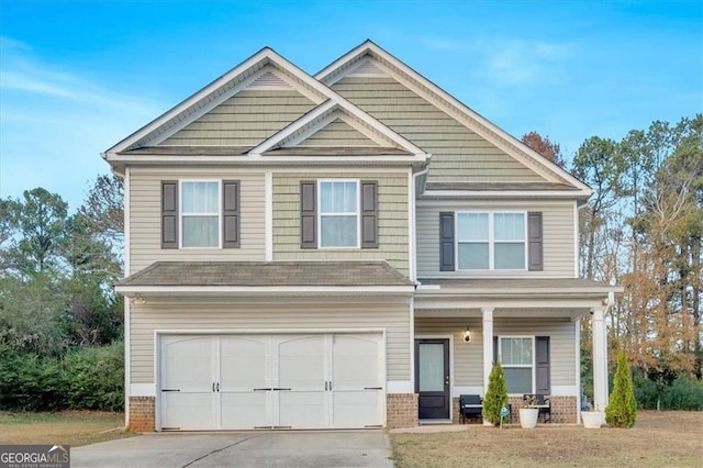 craftsman house featuring concrete driveway, brick siding, a garage, and a shingled roof