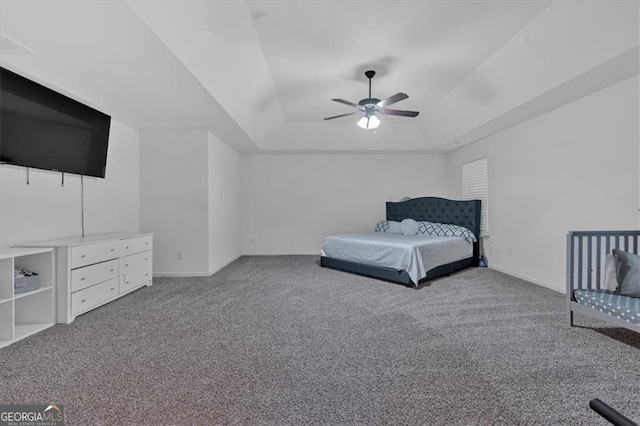 unfurnished bedroom with a ceiling fan, carpet, and a tray ceiling