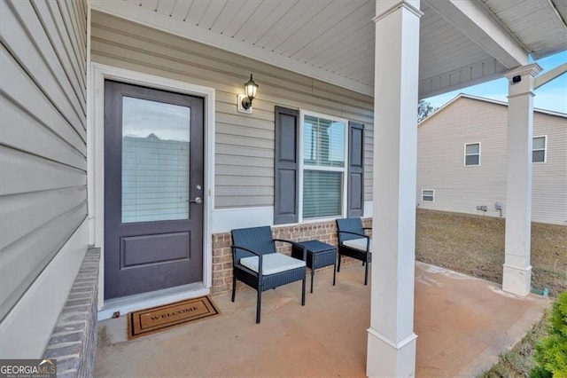 doorway to property featuring stone siding and a porch