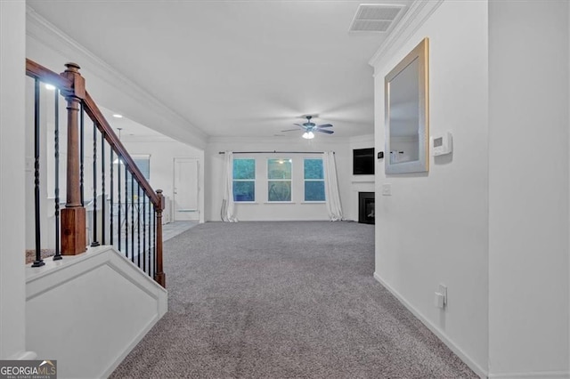 hall with stairway, baseboards, visible vents, carpet floors, and ornamental molding