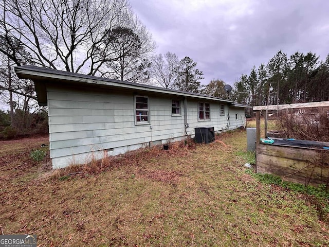 back of property featuring crawl space and central air condition unit