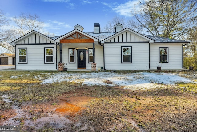 modern inspired farmhouse with board and batten siding and a chimney