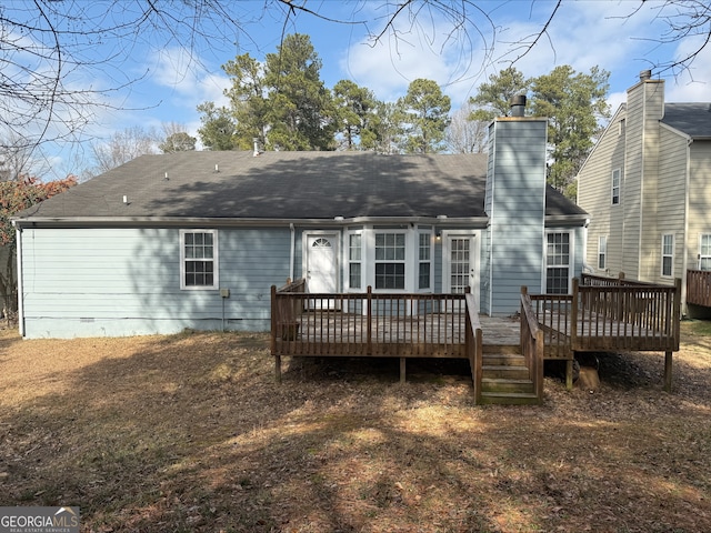 back of property with a shingled roof, a wooden deck, a chimney, and crawl space