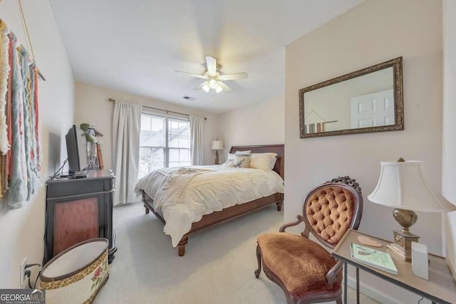 carpeted bedroom featuring visible vents and ceiling fan