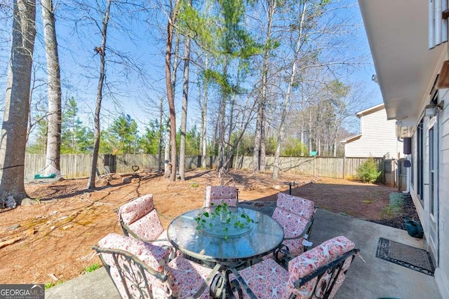 view of patio featuring a fenced backyard and outdoor dining space