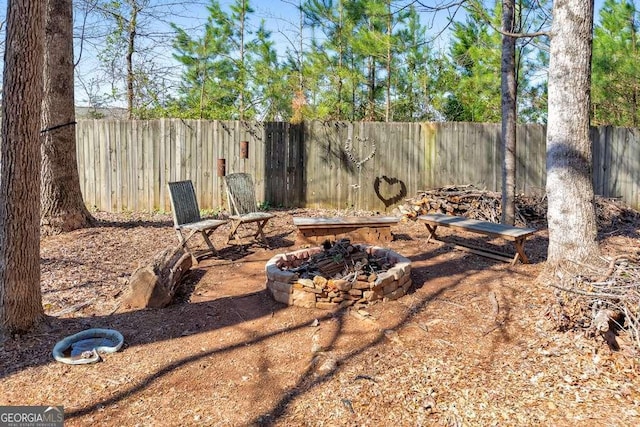 view of yard with a fire pit and a fenced backyard