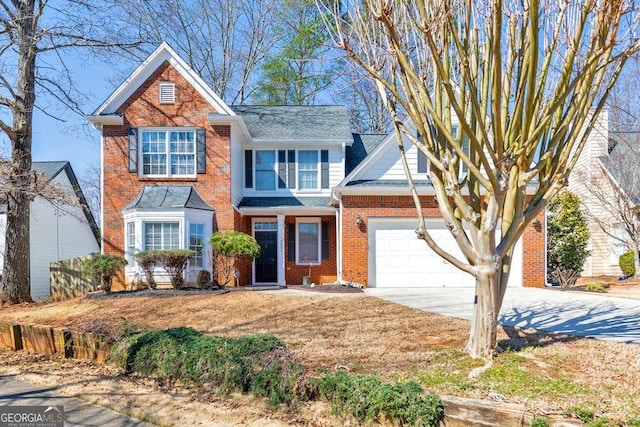 view of front of house featuring brick siding, driveway, and an attached garage