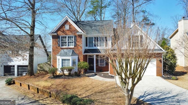 traditional home featuring concrete driveway, a balcony, a garage, and brick siding