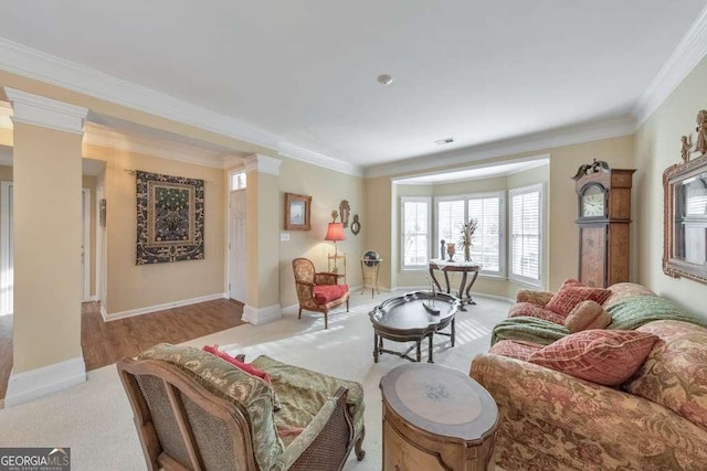 living room with visible vents, baseboards, and ornamental molding