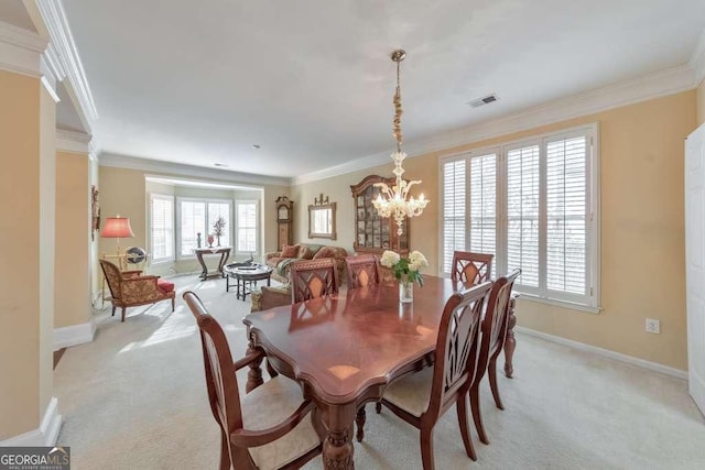 dining space featuring crown molding, light colored carpet, and a chandelier