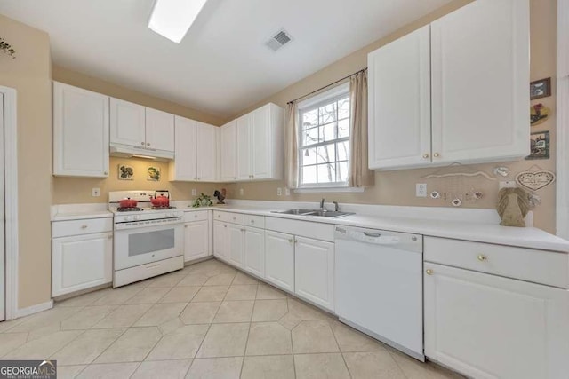 kitchen featuring white appliances, a sink, light countertops, white cabinets, and under cabinet range hood