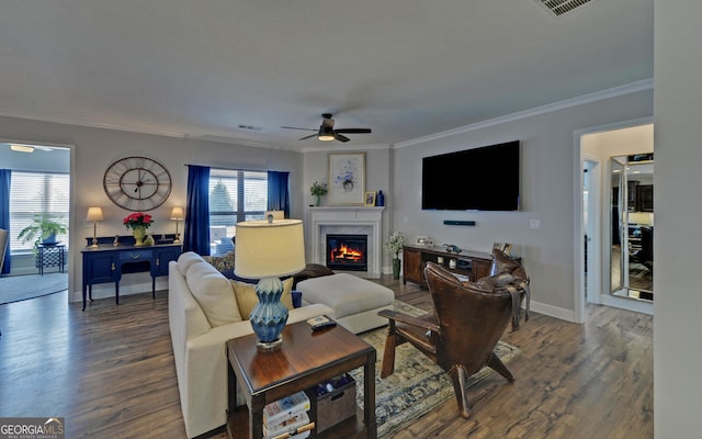 living area with plenty of natural light, a ceiling fan, and wood finished floors