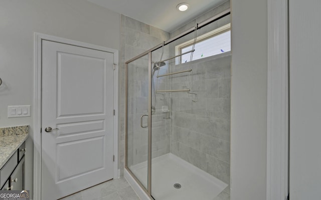 full bathroom featuring a stall shower and vanity