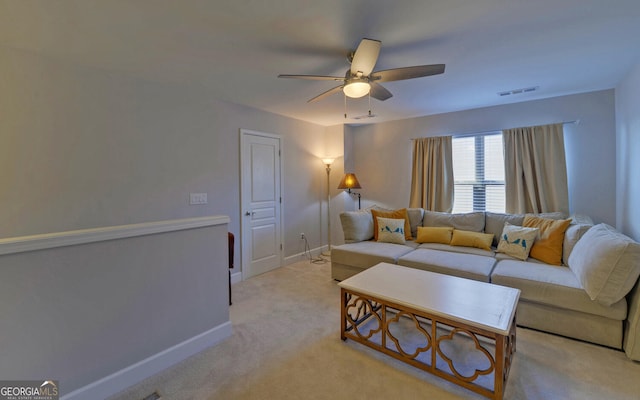 living room with light carpet, visible vents, baseboards, and ceiling fan