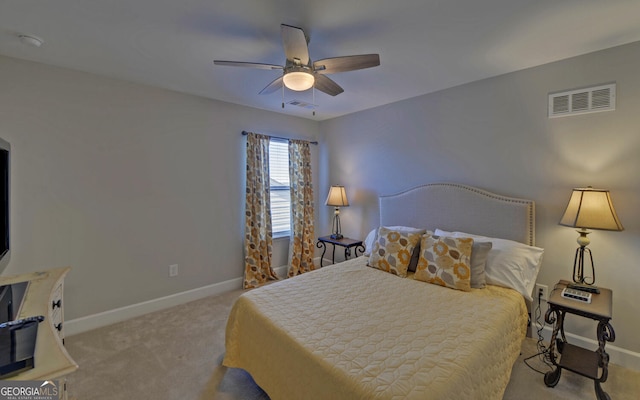 bedroom with ceiling fan, baseboards, visible vents, and light carpet