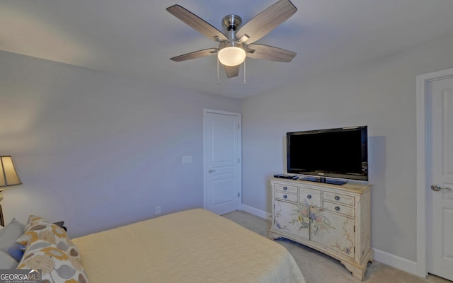 bedroom with a ceiling fan, baseboards, and light carpet