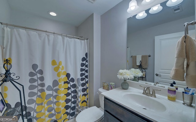 bathroom featuring vanity, toilet, a shower with curtain, and visible vents