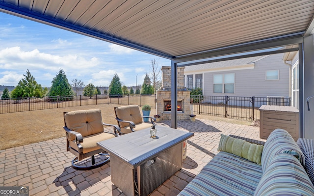 view of patio with a fenced backyard and an outdoor living space with a fireplace