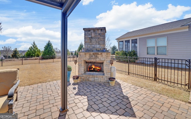 view of patio featuring a fenced backyard and an outdoor stone fireplace