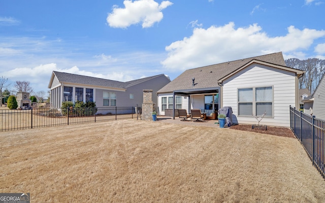 rear view of house with a patio area, a fenced backyard, a lawn, and a shingled roof