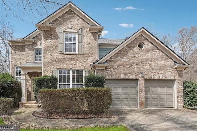 traditional-style house featuring a garage and driveway