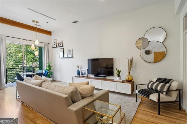 living area with visible vents and light wood-style flooring