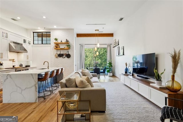 living room with recessed lighting and light wood-style floors