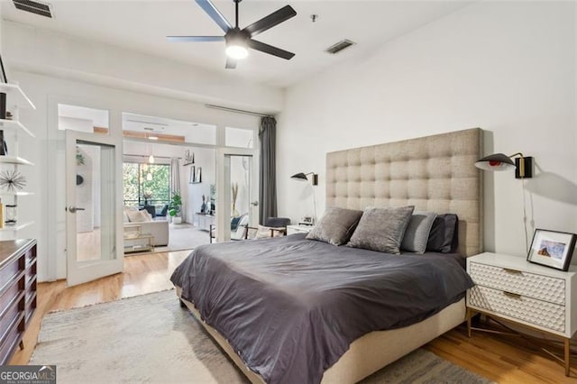 bedroom with visible vents, light wood-style floors, access to exterior, and a ceiling fan