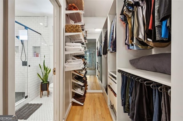 walk in closet featuring light wood-style floors