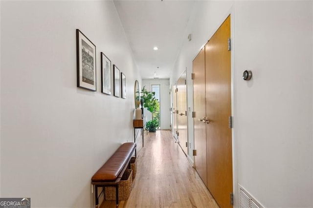 corridor with recessed lighting, visible vents, and light wood-style flooring