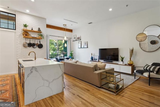 living area with light wood-style flooring and recessed lighting