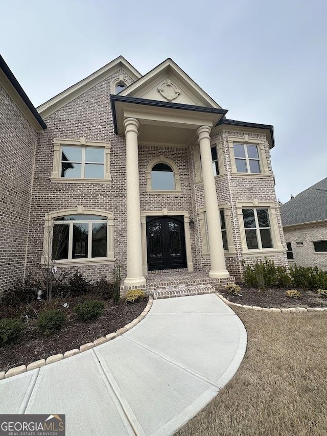 greek revival inspired property with brick siding