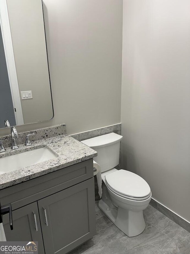 bathroom with toilet and vanity