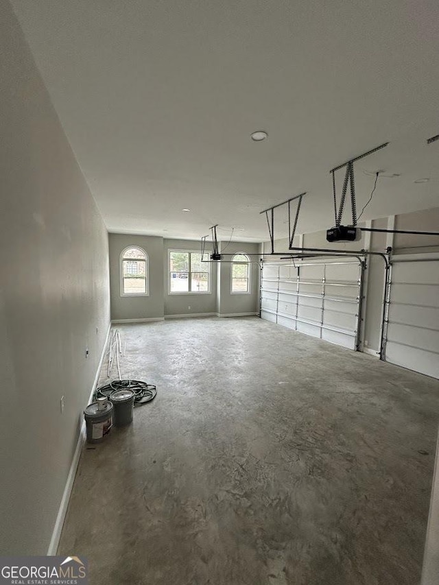 garage featuring baseboards and a garage door opener