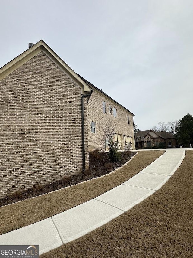 view of side of property featuring brick siding