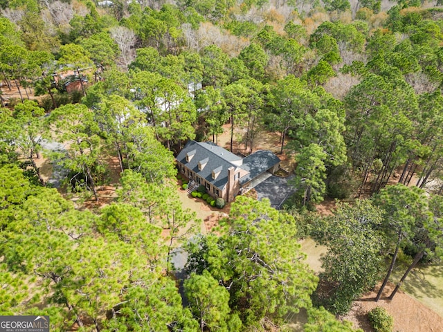 birds eye view of property with a view of trees